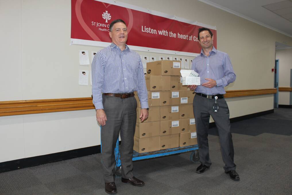RFS donations: Dr David Doolan, HDHS Director of Medical Services, and Adam Gosling, HDHS Pharmacy Manager, prepare the saline vials. Picture: Supplied