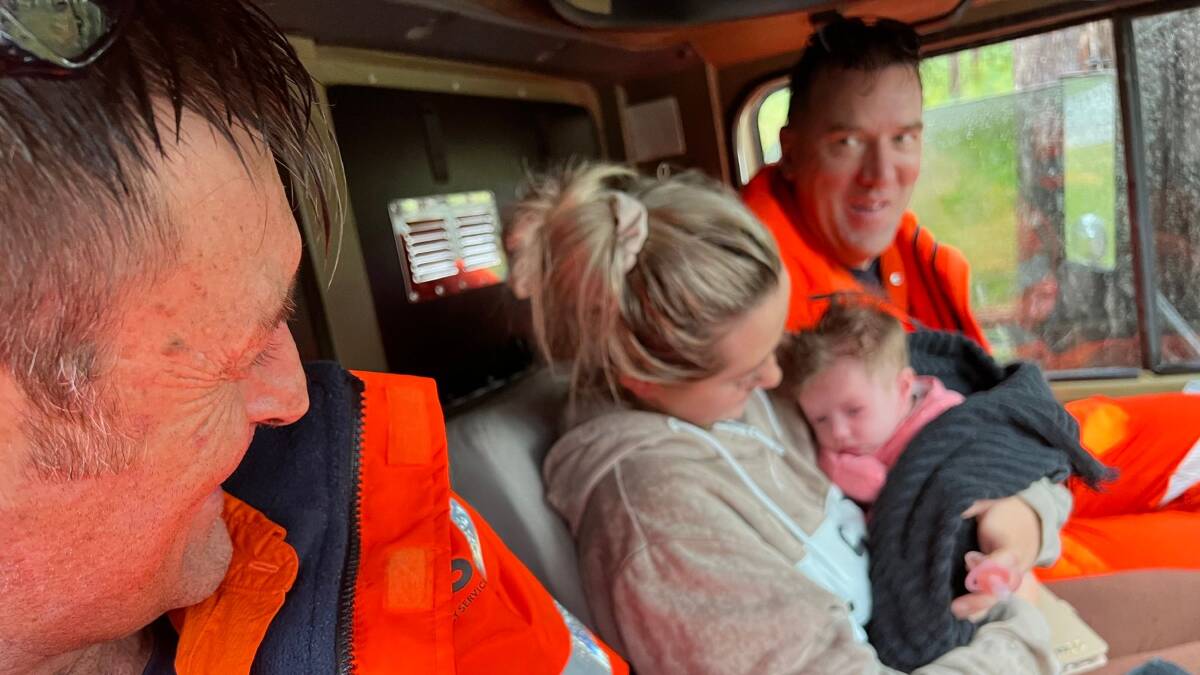 A mother and her six-week-old daughter are rescued from a home in Gronos Point after flood water isolated them. Picture: NSW SES Hawkesbury Unit/Facebook
