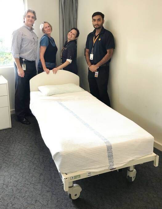 Help needed: Efraim, Cathy, Paula and Ravi with one of the old hospital beds that will be donated to charity. Picture: Supplied