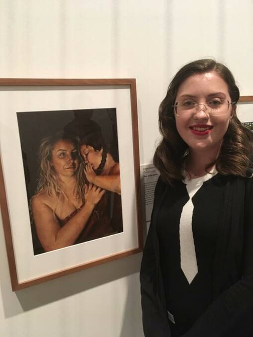 BEHIND HER EYES: Casey Sessions with her Young Archie finalist painting The Child Within. Picture: Supplied