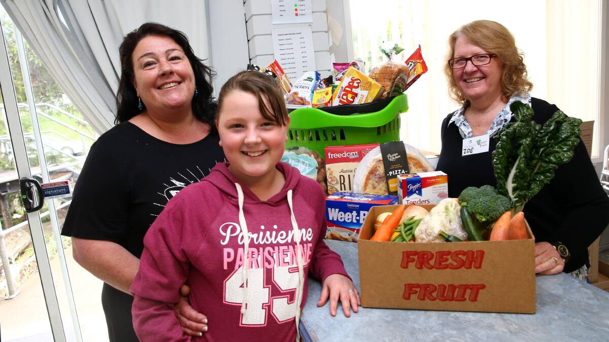 Volunteers serve locals at Hawkesbury Community FoodCare. Pictures: Geoff Jones