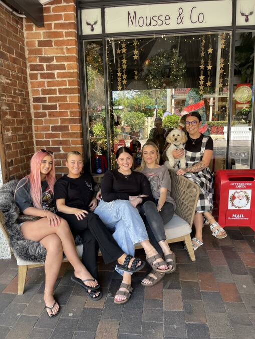The Mousse & Co team, Charlot, Ren, Bella, Hayley, Lola the dog, and business owner Monique, with Santa's letterbox outside their shop. Picture supplied