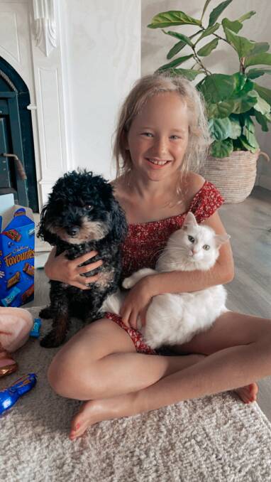 Luella with Princess the adopted cat and her mate Kenny the cavoodle. Picture: Supplied
