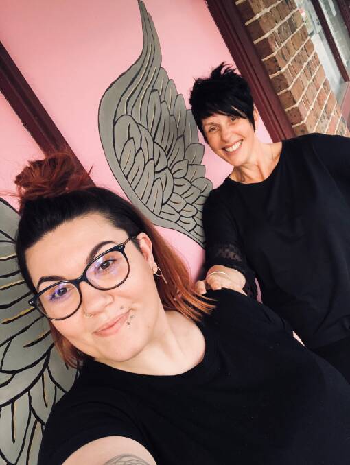 PINK UP: Norwest Private’s breast care nurse Ros Williams (right) and her daughter Monique who owns Mousse & Co in Windsor, pictured at the Pink Finss mural outside the Hawkesbury Gazette office in Richmond. Picture: Supplied