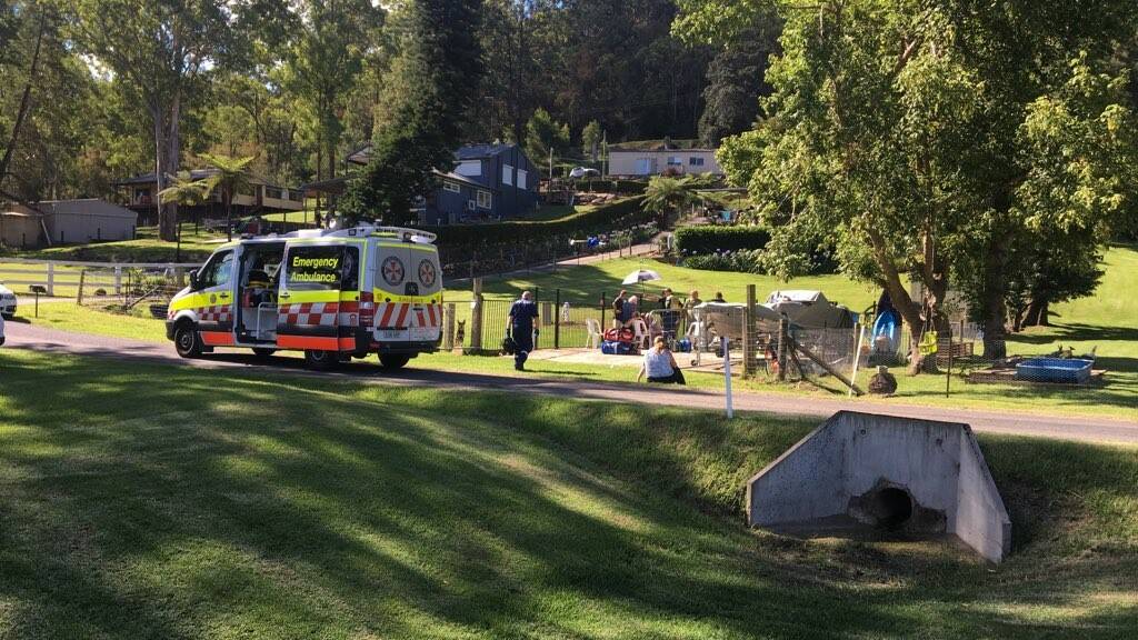 Paramedics assist the three girls at Cumberland Reach, next to the Hawkesbury River. Picture: CareFlight
