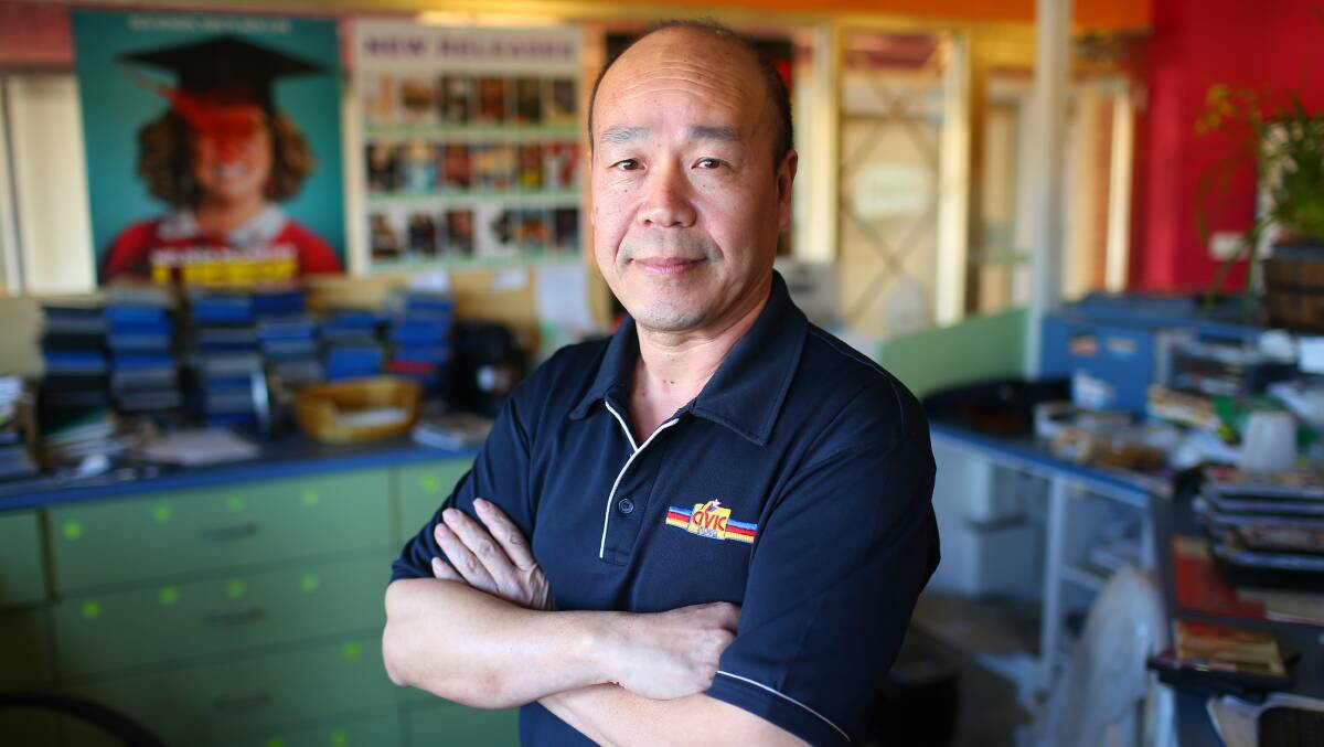 MOVIE BUFF: Guirong Wu at his shop Civic Video Windsor in the Old Post Office Arcade. Picture: Geoff Jones