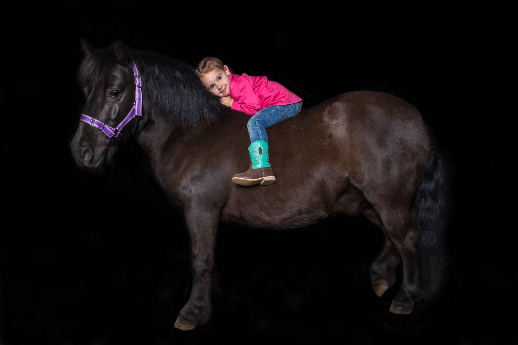 Best mates: Isla is responsible for feeding, brushing and washing Spikey the pony. Isla's mum, Danielle, says the two are "best friends". Picture: Geoff Jones