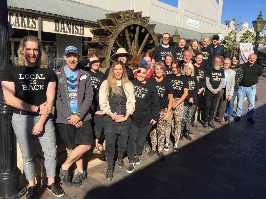 Local is back: Manor on George co-owner Benjamin Woodbury (L) and Windsor Mall business-owners gather at the iconic wagon wheel water feature in the mall to promote 'buying local', as part of the Local Is Back business initiative. Picture: Sarah Falson