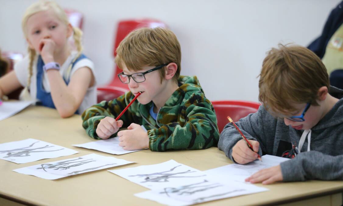 Children attend the Superhero Comic Art workshop at the Hawkesbury Central Library. Pictures: Geoff Jones