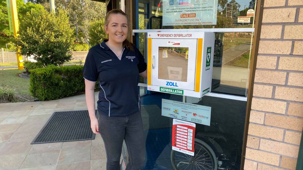 LIFE SAVING: Wisemans Ferry resident Sophie Wills with an automated external defibrillator (AED) installed outside Wisemans Ferry Bowling Club in collaboration between the community defibrillator project and the club. Picture: Supplied