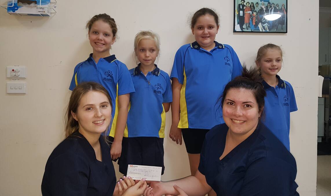 Donation: 1st Kurrajong Junior Guides Matilda Maunder, Eloise Pridham, Chloe McDonald and Lexie Knott, with Kurrajong Nursing Home's Georgia Butler and Maddie Alcorn. Picture: Supplied