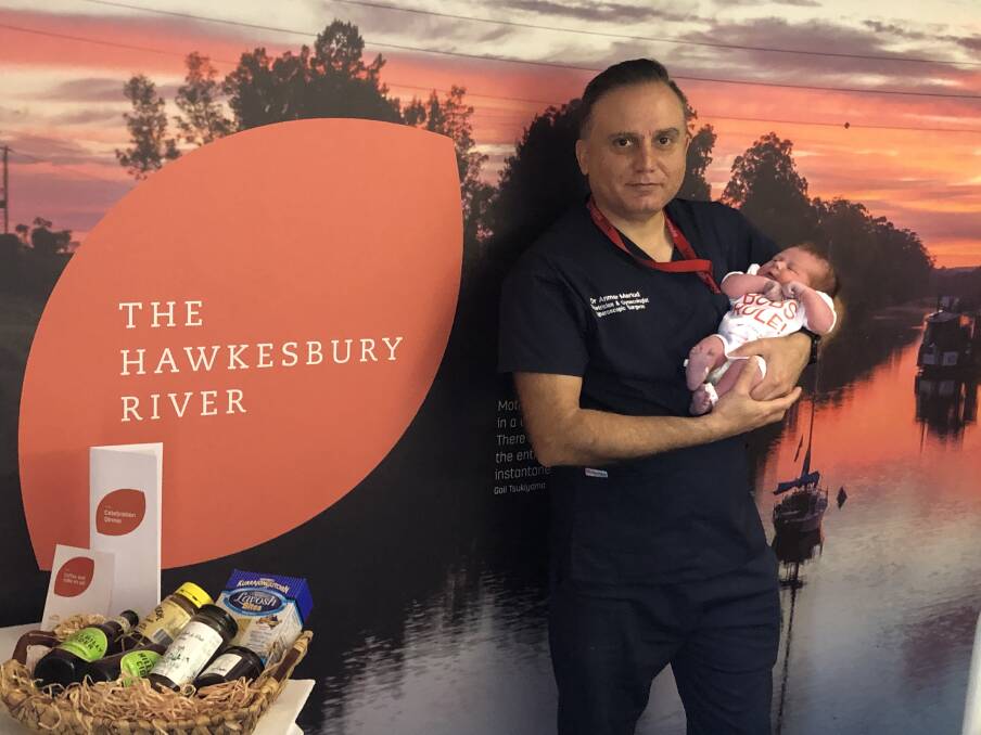 Gold class service: Hawkesbury obstetrician and gyeanocologist Dr Anmar Mariud with Georgia, one of the first babies to be born in the new private maternity ward, and a pack of local goodies that Georgia's parents will take home. Picture: Supplied