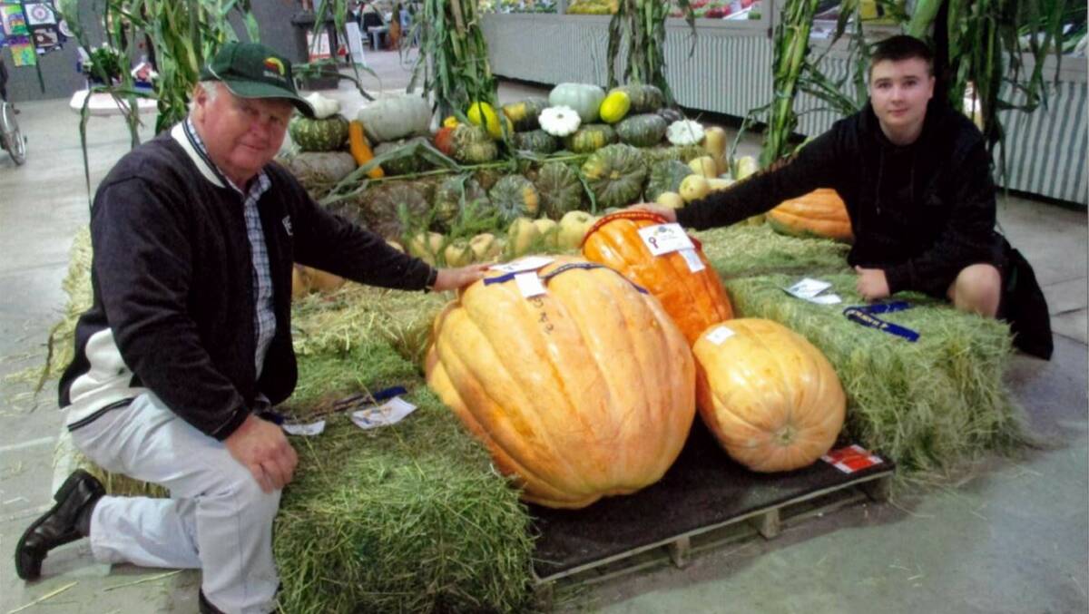 In the family: Rodney Simmons (left) and his grandson Connor with their award-winning giant pumpkins at the 2019 Hawkesbury Show. Picture: Supplied