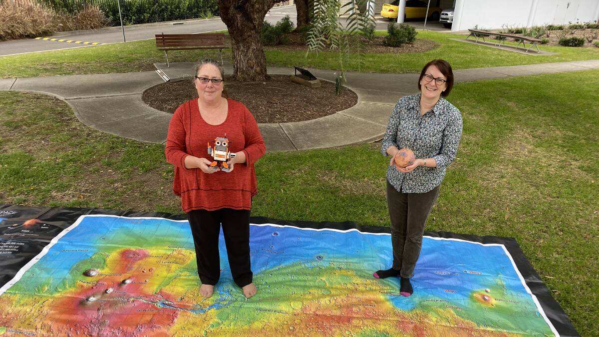 Wattle happen?: One Giant Leap Australia Foundation Founder Jackie Carpenter and Federal Member for Macquarie Susan Templeman pictured standing on a giant map of Mars are encouraging local schools to register their interest in taking part in a new space experiment. Picture: Supplied
