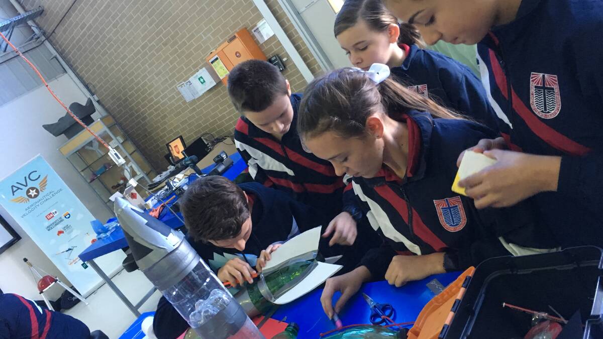 PREPARATIONS: The students refining their rocket which went on to win the Western Sydney Hub Semi Finals at Western Sydney University.