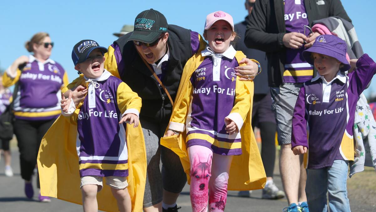 SMALL STEPS: Purple is an important part of the colour scheme for Hawkesbury Relay For Life. These relayers were snapped in 2017. Picture: Geoff Jones