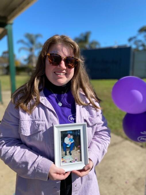 Gemma Healey, 23 holds a photo of her dad, Jeffrey Gibbson, who passed away from pancreatic cancer in 2020. She wants others to heed her 'early detection' message and get checked. Picture: Supplied