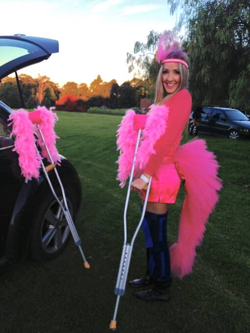 The show must go on: Lynette McKinley's daughter Belle dressed as a flamingo for a dress-up party, right after she broke her knee. Picture: Lynette McKinley
