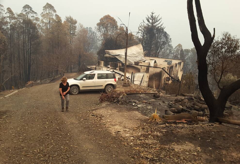 Robyn out the front of the rubble of Shambala Sanctuary. Photo submitted