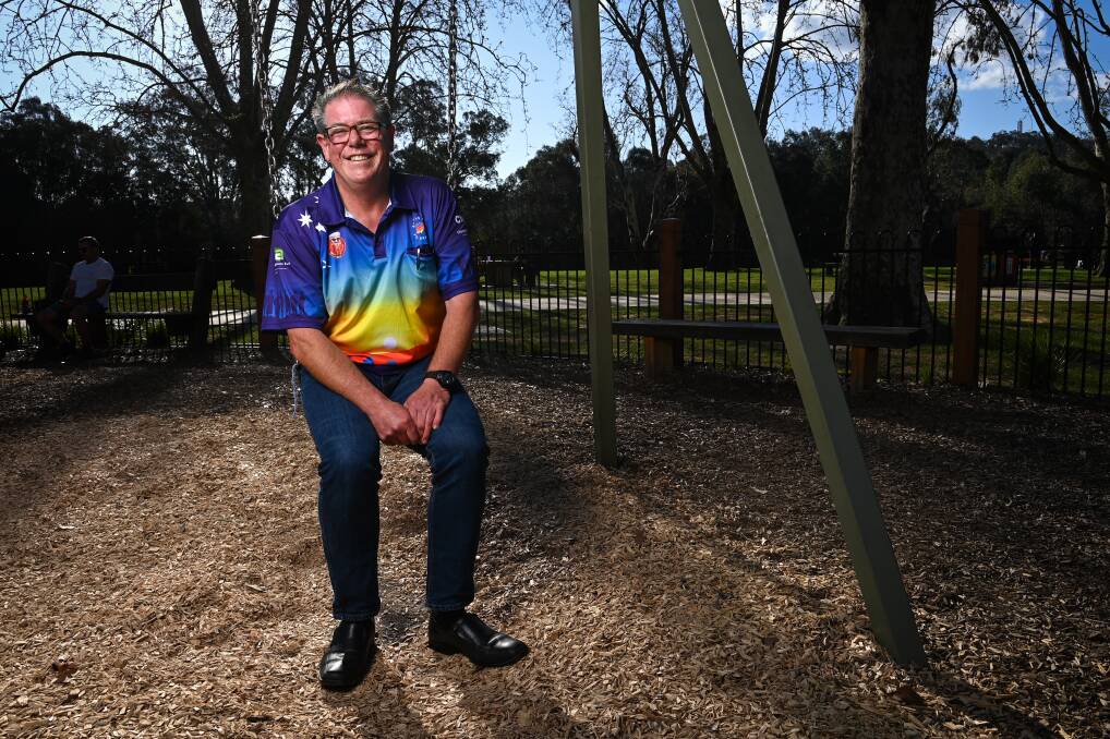 NOW: Darryl Coventry pictured on a swing at Albury's Noreuil Park playground this week in a Bowls for Gr8 Brains shirt. That is the organisation the former Queensland policeman helped establish with past Border police boss Beth Docksey. Picture: MARK JESSER