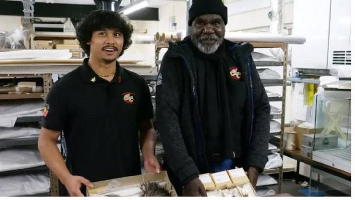 TRADITION: Mangubadijarri Yanner and Donald Bob oversee the transfer of the artifacts in Manchester. Photo: AIATSIS
