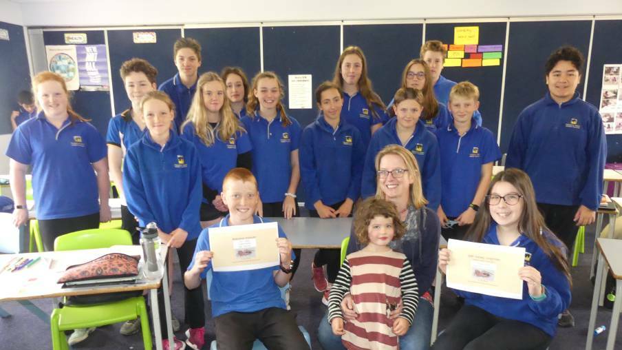 NEW SPIDER: Arachnologist Dr Jess Marsh with her daughter, winning students Samuel Coleby and Chaeli Rowley, and the rest of the KICE Year 8 science class at Kingscote. Photo: Stan Gorton