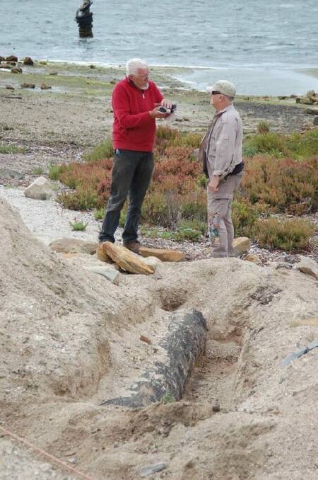 RIG president Tony Klieve and American River harbour master Ian King discuss the newly-discovered log back in 2016. Photo RIG 