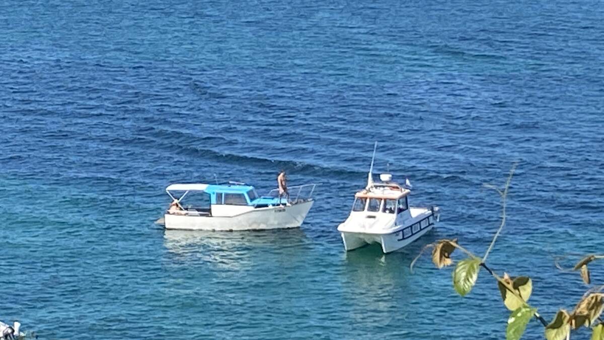 On patrol: A NSW Maritime vessel approaches boaters in Salmon Haul, in the Port Hacking, recently. Pictures: Merryn Porter 
