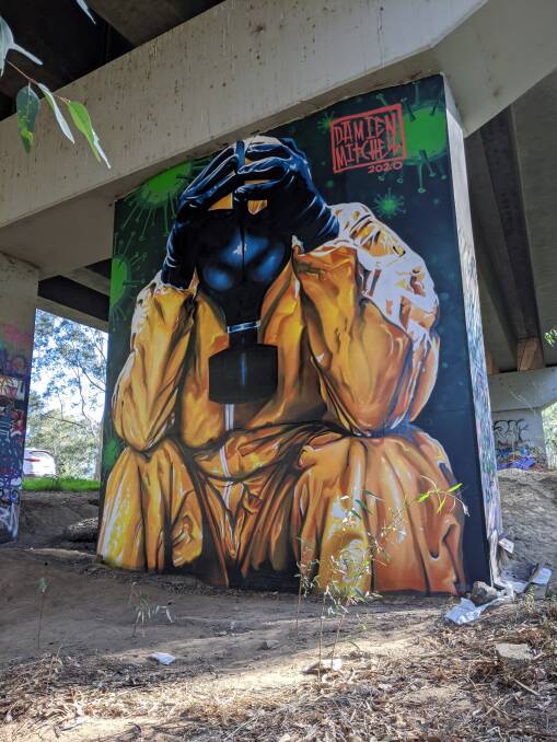 A mural under a Wagga bridge dedicated to the medical workers putting their lives at risk. Picture: Damien Mitchell. 