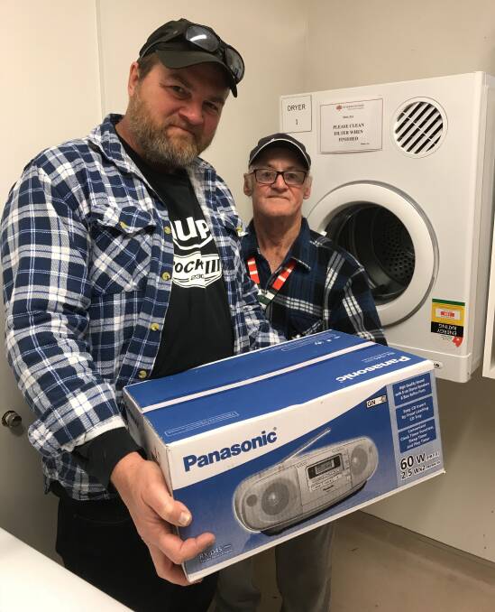Jason Smith and Peter Lee with he Xavier Unit's new stereo and clothes dryer.