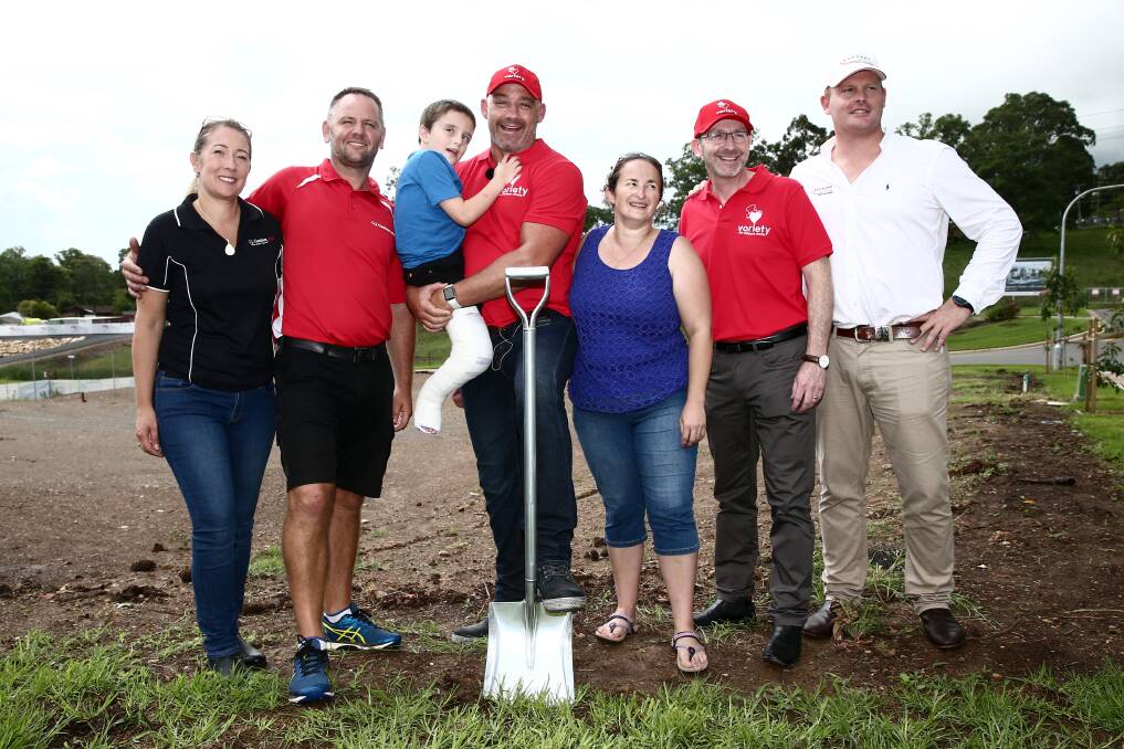 Working together: Former Panthers NRL great Mark Geyer with young Jayden, his mum Leigh, and representatives from Redbank, G.J. Gardner Homes and Variety. Picture: Geoff Jones