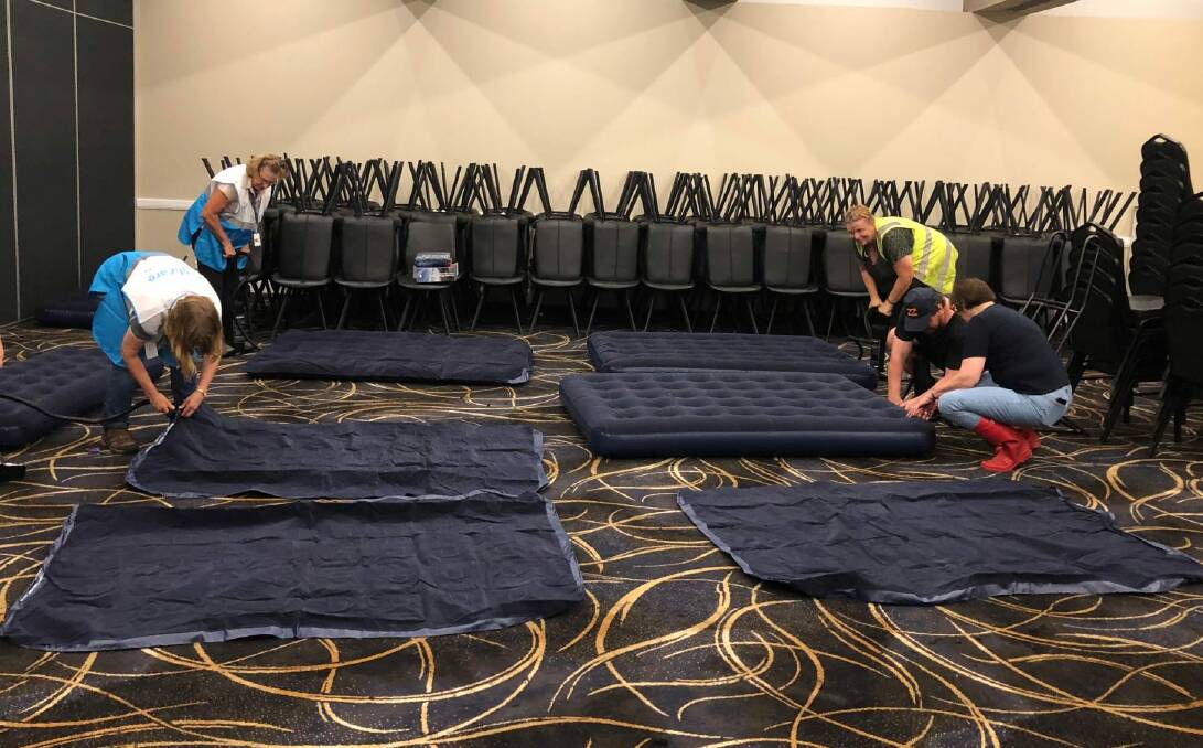 Helping hands: Volunteers inflate mattresses at Richmond Club for those having to evacuate their homes due to the floods. Picture: Susan Templeman MP Facebook page