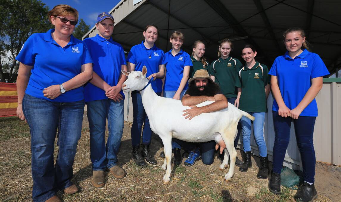 Class effort: Celebrity gardener Costa Georgiadis with Demeter the goat, Liz Ruis and students from Windsor High School at Hawkesbury Show. Picture: Geoff Jones