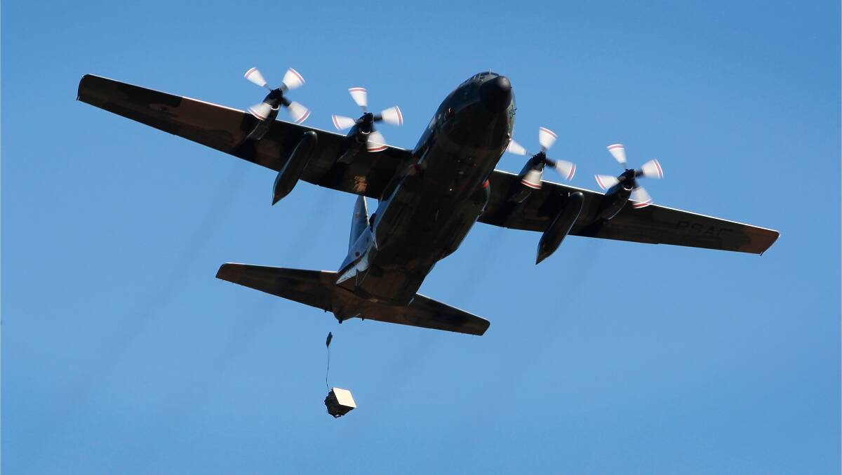 A Republic of Singapore Air Force C-130 Hercules, from No 122 Squadron, conducts an airdrop over Londonderry Drop Zone. Image by Sgt. Ricky Fuller.