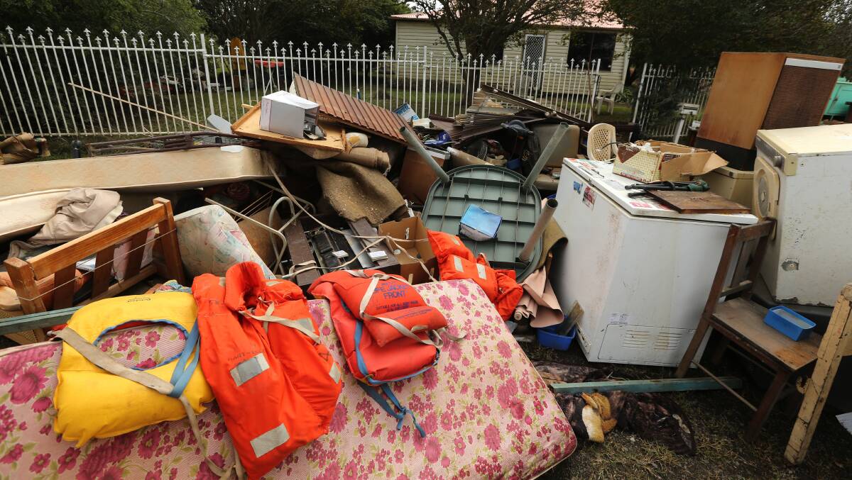 Rubbish for collection outside of a Pitt Town property following the March flood. Picture: Geoff Jones