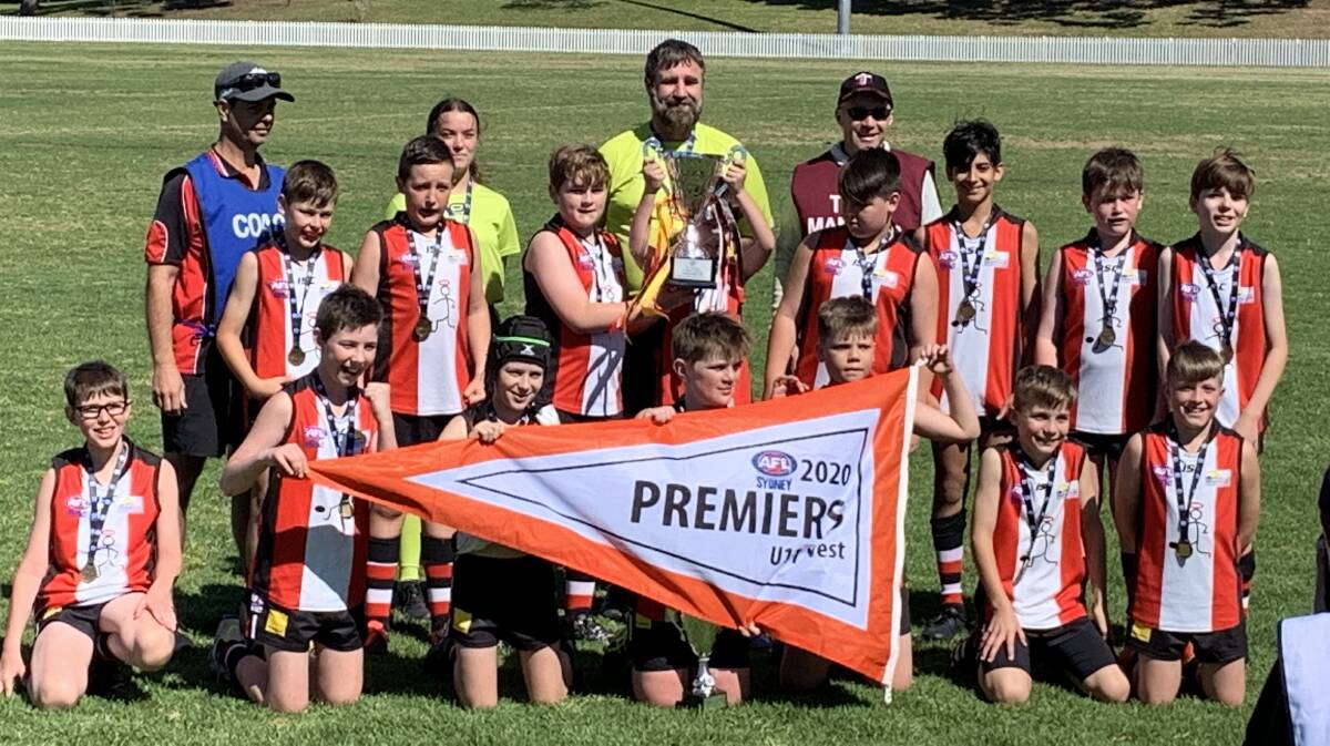 The winning Under 11 Saints with their medals and premiership trophy. Picture: Supplied