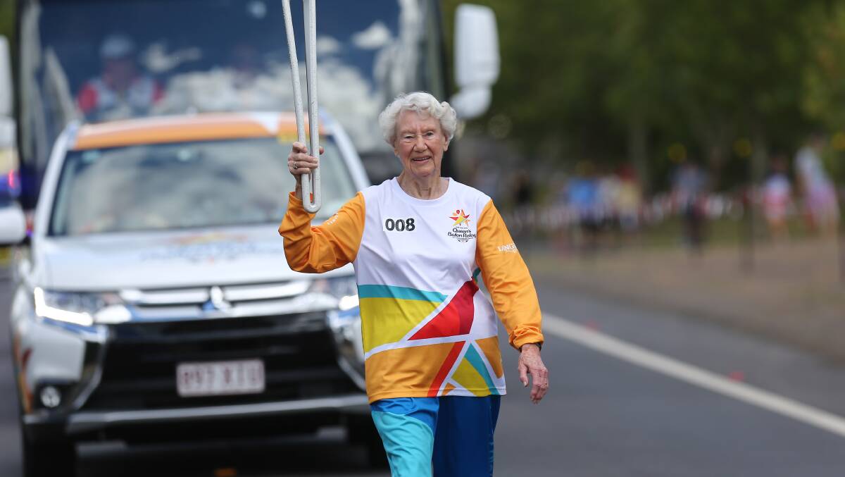 Heather Lee, pictured while walking with the Commonwealth Games baton, broke two world records at the Australian Masters Athletics Championships. Picture: Geoff Jones