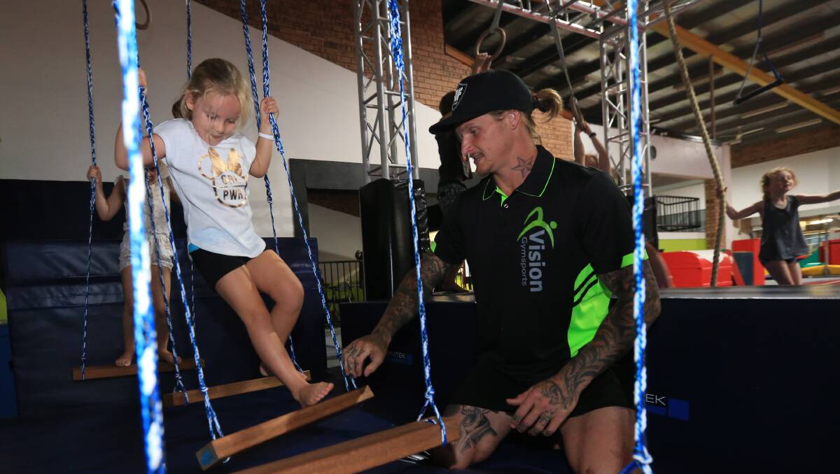 Warrior Daniel Walker takes youngsters through an obstacle course he set up at Vision GymSports. Picture: Geoff Jones