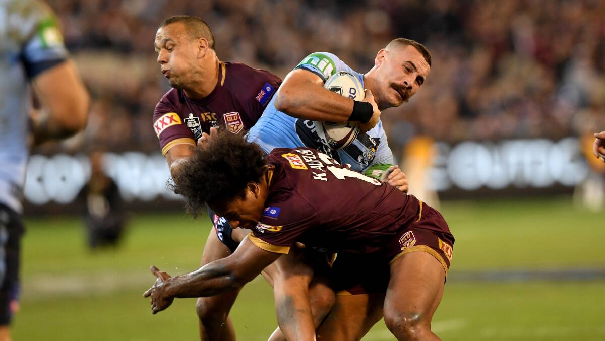 Reagan Campbell-Gillard of the Blues is tackled by Felise Kaufusi and Will Chambers during his State of Origin debut on June 6. Picture: AAP Image/Joe Castro