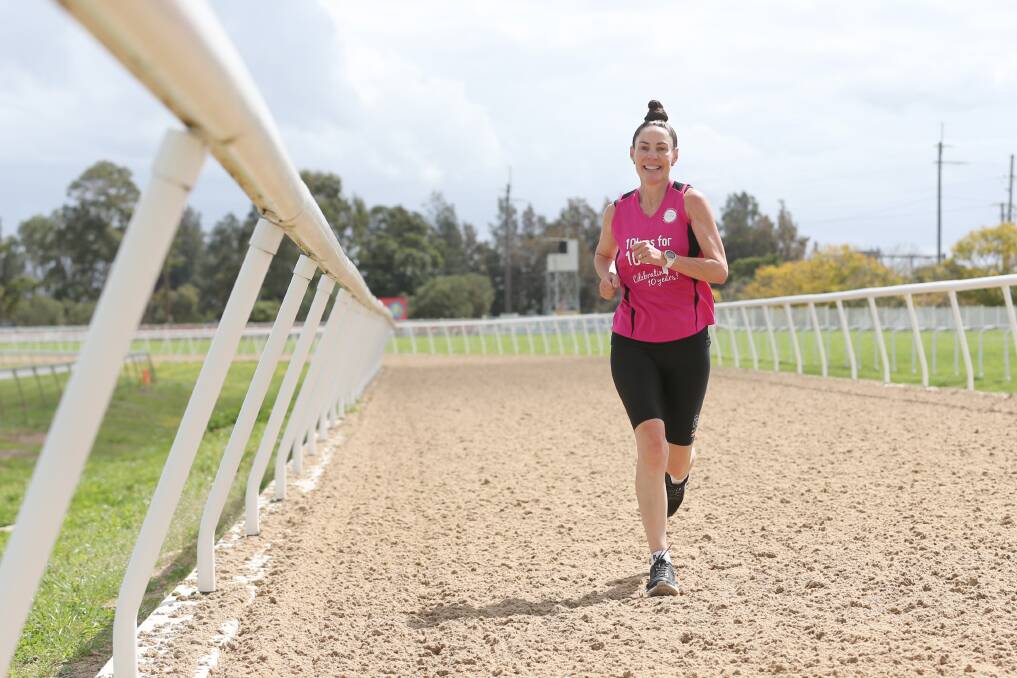 Hitting the track: Pink Finss founder Jodie Amor kicks-off her first day of running 10 kilometres to raise money for Pink Finss, at the Hawkesbury Race Club in Clarendon. Picture: Geoff Jones