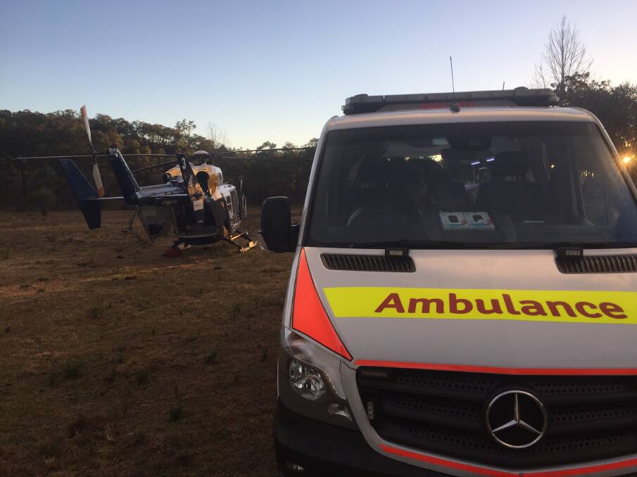 Crash: The CareFlight helicopter and NSw Ambulance at the scene of the crash. Picture: CareFlight.