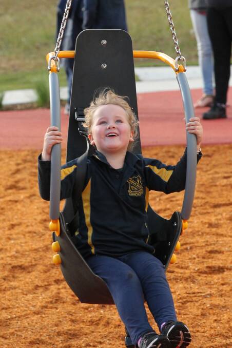 Fun times: One of the young attendees has a ball on a swing at the opening of the park on Monday. Pictures: Geoff Jones.