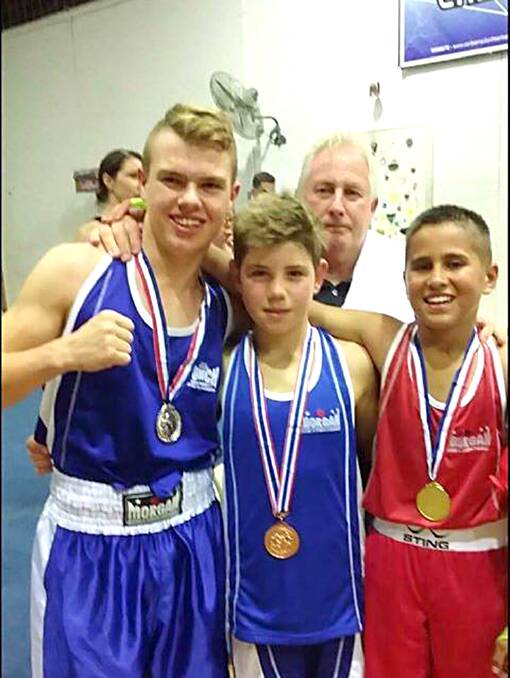 Young fighter: Daniel Flaxman (left) alongside fellow Boxfitt Gym fighters Mitchell Bartolo and Tyrell Adams, after their tournament in Canberra on April 6. Picture: Supplied.