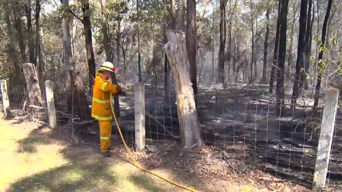 Mopping up: A firefighter on scene at the East Kurrajong grass fire. Picture: TNV.