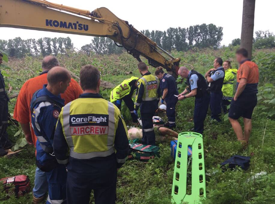 Hospitalised: The man is assisted at the scene of the incident. Picture: CareFlight.