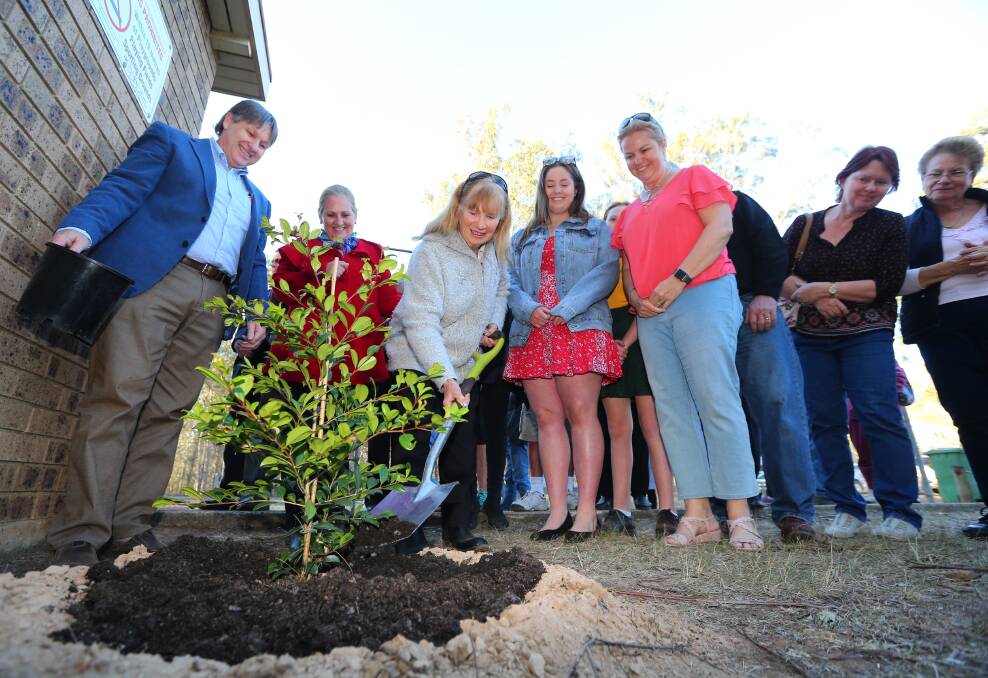 Memorial: Betty Turner helps plant a tree at the Maraylya tennis courts in honour of her late husband, Ray. Picture: Geoff Jones.