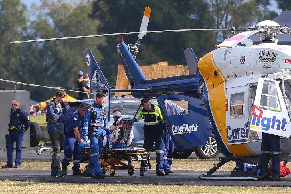 Blow to head: Mr Toohey is taken to the CareFlight helicopter for transportation to Westmead Hospital.