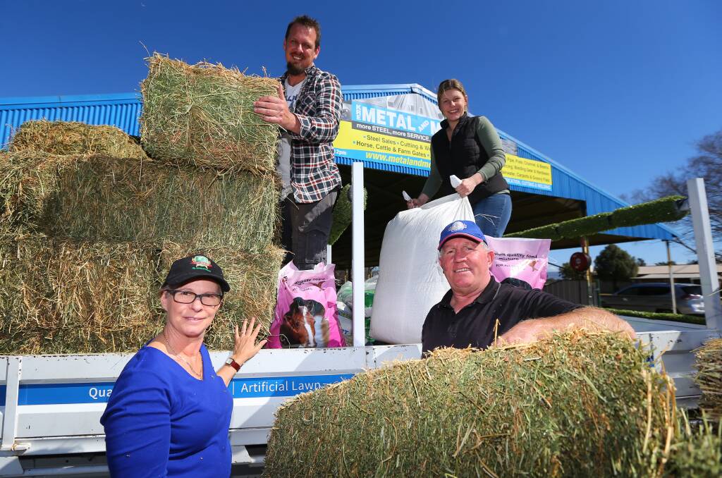 Donations: Hawkesbury District Drought Relief organiser Graham Williams (right), his wife Kim, daughter Jade and Brad McCleary unloading donations at the Hawkesbury Showground. Picture: Geoff Jones.