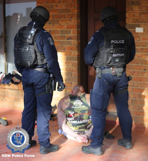 Arrest: Police with the man at Sackville. Picture: NSW Police.