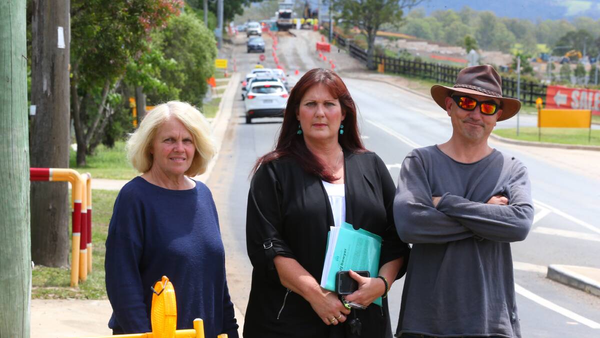 Frustration: Community members Pauline Alchin, Marie-Jeanne (MJ) Bowyer and Justin Lewis at the site of road works on Grose Vale Road at the Redbank development. Picture: Geoff Jones.